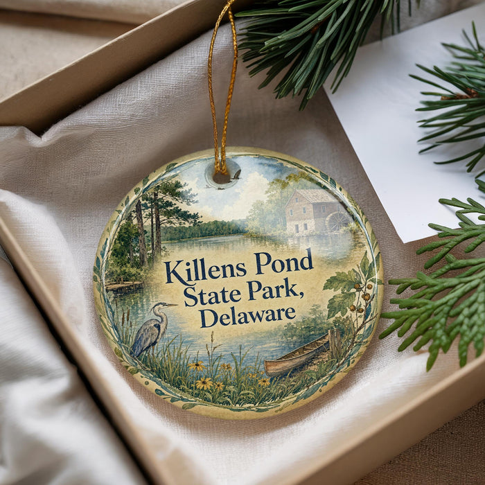 A decorative ornament with a scenic image of Killens Pond State Park, Delaware, hanging from a string.