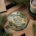 A decorative ornament featuring a scenic landscape of Kincaid Lake State Park, Kentucky, with a bench and pine trees in the foreground.