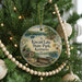 A round ornament hanging on a Christmas tree, featuring a scenic image of Kincaid Lake State Park, Kentucky.