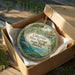 A decorative ornament in a box, featuring an illustration of a manatee and the text "Lafayette Blue Springs State Park, Florida".