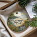 A decorative ornament with a scenic image of Lake Abquami State Park, Iowa, featuring a deer, a boat, and a waterfall.