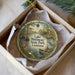 A decorative ornament in a box, featuring a painting of Lake Bistaineau State Park in Louisiana.