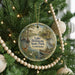 A round ornament hanging on a Christmas tree, featuring a scenic image of Lake Bistaineau State Park in Louisiana.