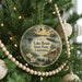 A round ornament hanging on a Christmas tree, featuring a scenic image of Lake Brun State Park in Louisiana.