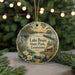 A decorative ornament featuring a scenic image of Lake Bruin State Park in Louisiana, with a bird and flowers in the foreground.