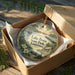 A decorative ornament in a wooden box, featuring a scenic image of Lake Bruin State Park in Louisiana.