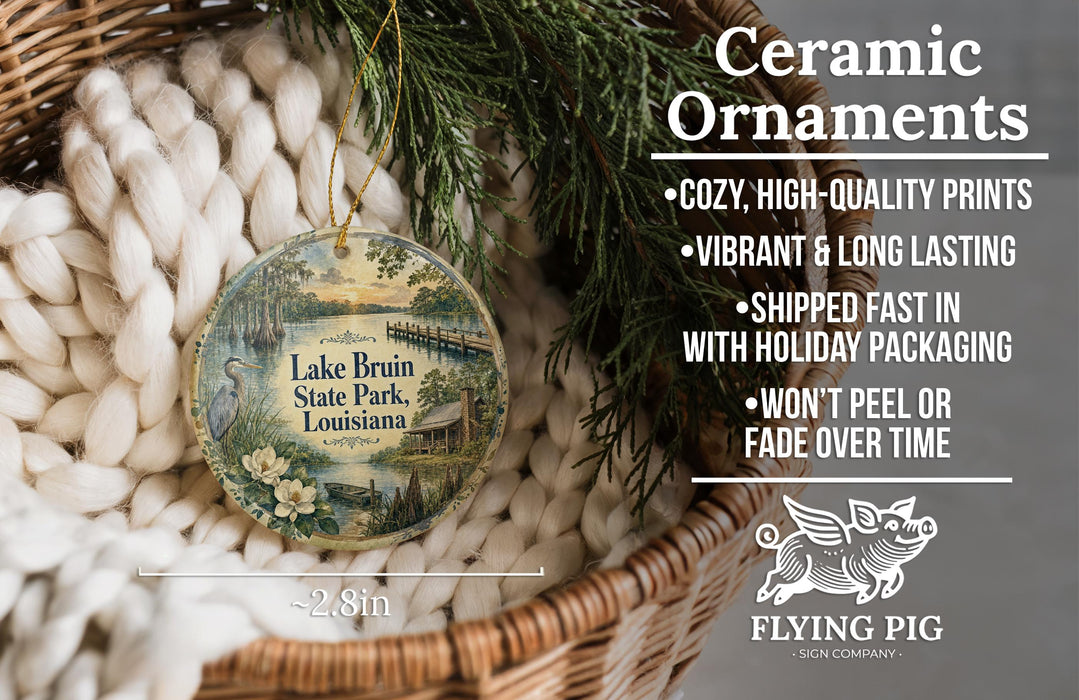 Ceramic ornaments, featuring a round ornament with a scenic image of Lake Brun State Park in Louisiana, hanging from a wicker basket.