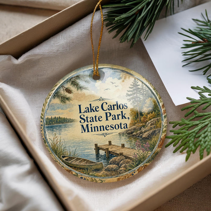 A decorative ornament with a scenic lake and pine trees, featuring the text "Lake Carlos State Park, Minnesota" on it.