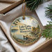 A decorative ornament with a scenic lake and pine trees, featuring the text "Lake Carlos State Park, Minnesota" on it.