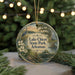 A circular ornament with a scenic image of Lake Chicot State Park, Arkansas, featuring a bird, flowers, and a wooden bridge.