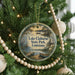 A round ornament hanging on a Christmas tree, featuring a scenic image of Lake Claiborne State Park in Louisiana.