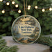 A circular ornament with a painting of Lake Claiborne State Park in Louisiana, featuring a boat, a bird, and a dock.