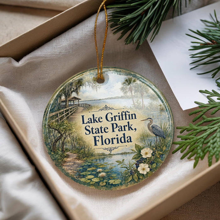 A decorative ornament with a scenic image of Lake Griffin State Park, Florida, hanging from a string.