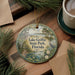 A decorative ornament featuring a scenic view of Lake Griffin State Park in Florida, surrounded by pine branches and a cup of coffee.