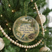 A round ornament hanging on a Christmas tree, featuring a scenic image of Lake June-in-Winter Scrub State Park, Florida.