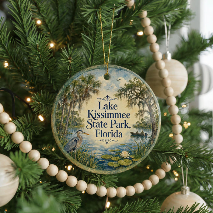 A round ornament hanging on a Christmas tree, featuring a scenic image of Lake Kissimmee, a park in Florida.