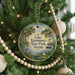 A round ornament hanging on a Christmas tree, featuring a scenic image of Lake Kissimmee, a park in Florida.
