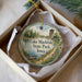 A decorative ornament in a box, featuring a scenic image of Lake Macbride State Park in Iowa.