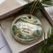 A decorative ornament in a box, featuring a scenic image of Lake Talquin State Park in Florida.