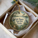 A decorative ornament in a box, featuring a scenic image of Lake Talquin State Park in Florida.