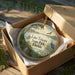 A decorative ornament in a wooden box, featuring a scenic image of Lake Talquin State Park in Florida.
