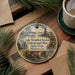 A decorative ornament featuring a scenic landscape with a lake, mountains, and a building, along with the text "Lake Vermilion-Soudan Underground Mine State Park, Minnesota".