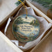 A decorative ornament in a white box, featuring a scenic landscape with a lake, trees, and a castle, along with the text "Lake Waramaug State Park, Connecticut".