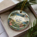 A decorative ornament with a scenic landscape of Lamoine State Park, Maine, featuring a lighthouse and surrounding natural elements.