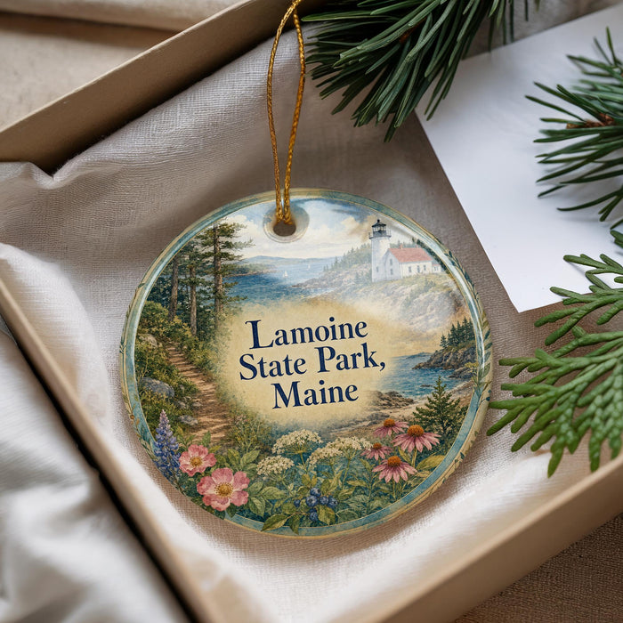 A decorative ornament with a scenic landscape of Lameoine State Park, Maine, featuring a lighthouse and surrounding natural scenery.
