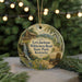 A round ornament featuring a scenic landscape with a cabin, a wagon, and a waterfall, surrounded by greenery and trees.