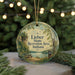 A round ornament with a scenic image of a park and a lake, featuring the text " Lieber State Recreation Area, Indiana" and a bench.