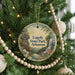 A round ornament hanging on a Christmas tree, featuring a scenic image of Loggy State Park in Arkansas.