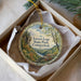 A decorative ornament in a box, featuring a scenic landscape with a river and trees, along with the text "Lovers Leap State Park, Connecticut".