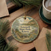 A round ornament with a scenic landscape of Lovewell State Park, Kansas, featuring a house, trees, and a lake.