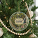 A round ornament hanging on a Christmas tree, featuring a scenic image of the state park in Connecticut.