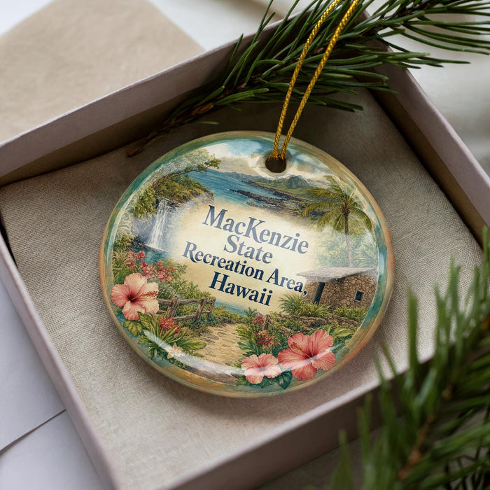 A decorative ornament in a box, featuring a tropical landscape with palm trees, flowers, and a waterfall.