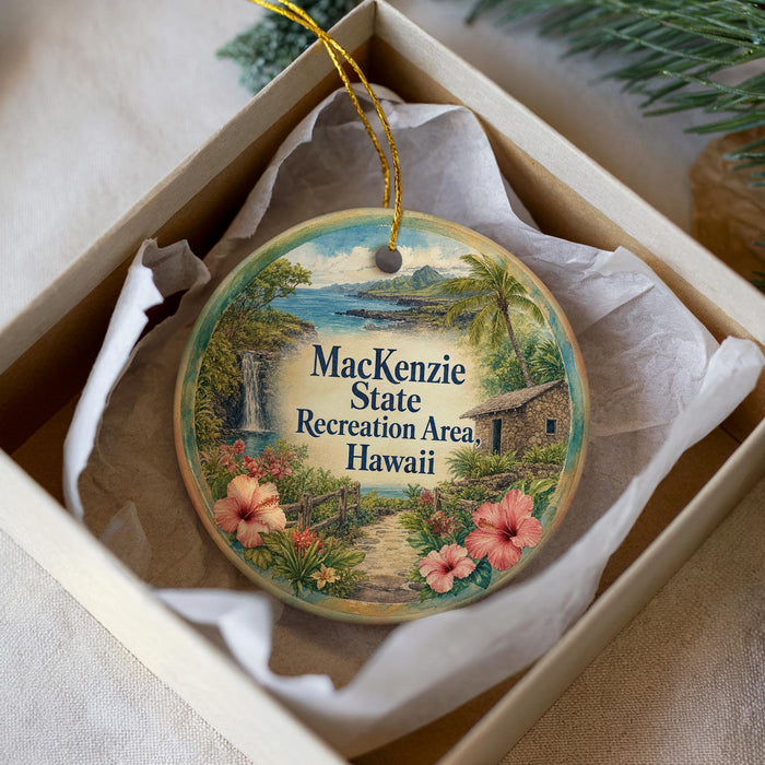 A circular ornament with a tropical landscape design, featuring a waterfall, palm trees, and flowers, is displayed in a box.