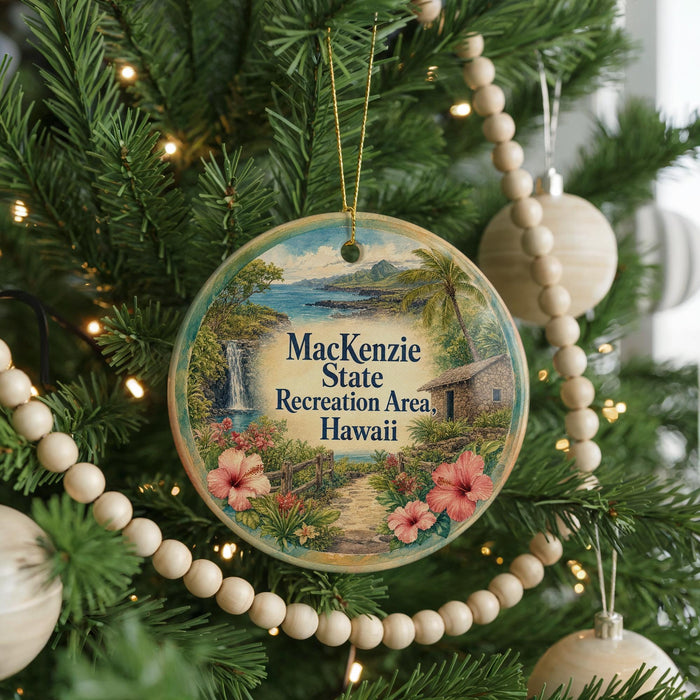 A circular ornament hanging on a Christmas tree, featuring a tropical landscape with a waterfall and hibiscus flowers.