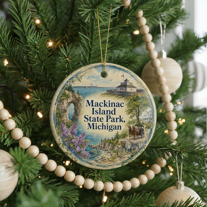 A round ornament hanging on a Christmas tree, featuring a scenic image of Mackinac Island, Michigan.