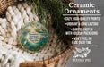 Ceramic ornaments, featuring a painting of Manatee Springs State Park, Florida, hanging in a basket with pine branches.