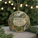 A circular ornament with a scenic forest landscape and text, hanging on a string.