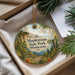 A decorative ornament with a scenic image of Maplewood State Park, Minnesota, hanging from a string.