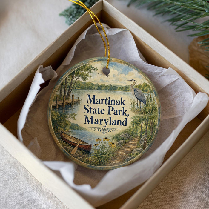 A decorative ornament in a box, featuring a scenic image of Martinak State Park, Maryland.