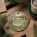 A round ornament with a scenic landscape of Massanutten State Park, Massachusetts, featuring pine trees, a lake, and a castle.