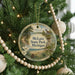 A round ornament hanging on a Christmas tree, featuring a scenic image of Michigan State Park.