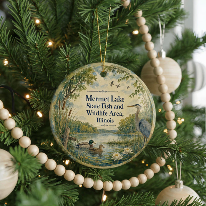 A round ornament hanging on a Christmas tree, featuring a scene of ducks swimming in a pond surrounded by trees and greenery.