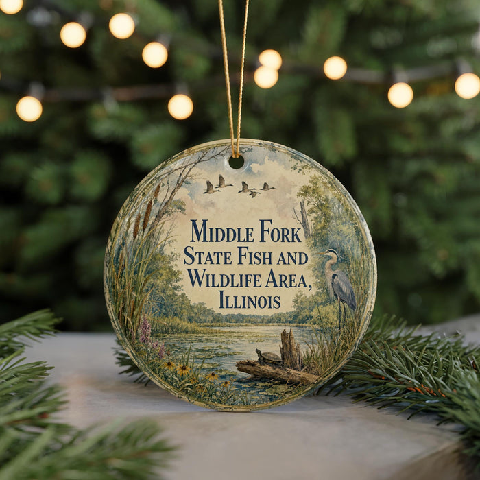 A round ornament with a scenic image of a lake, birds, and trees, along with the text "Middle Fork State Fish and Wildlife Area, Illinois".