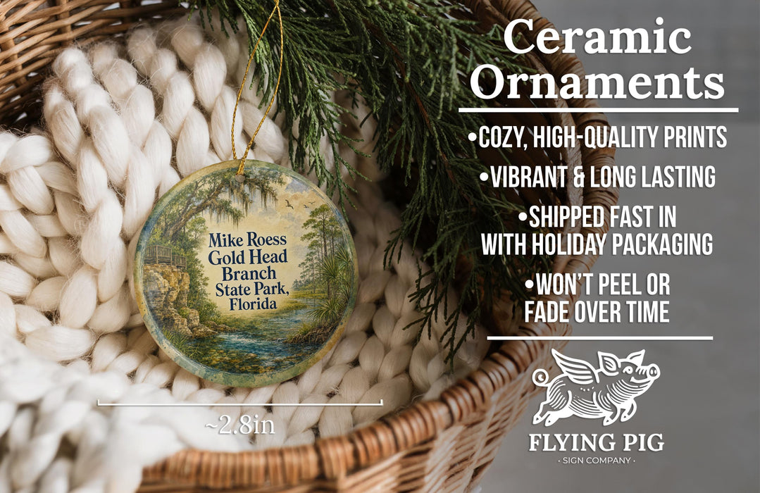 Ceramic ornaments, featuring a painting of a landscape with a river, are displayed in a basket.