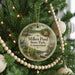 A round ornament hanging on a Christmas tree, featuring a scenic image of Millers Pond State Park in Connecticut.