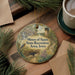 A round ornament with a scenic illustration of a forest and a bird, along with the text "Mines of Spain State Recreation Area, Iowa".